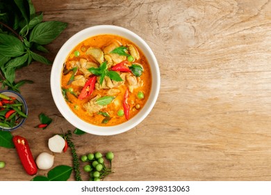 Chicken green curry Asian food, Beef green curry Thai food on a soup bowl with a mixture of herbs, vegetables and Thai red chilli spices. Top view. - Powered by Shutterstock