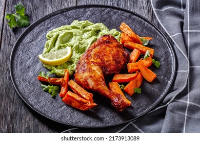 Chicken With Guasacaca Sauce Of Avocado, Green Pepper And Herbs And Sweet Potato Chips On Black Plate On Wooden Table, Horizontal View From Above