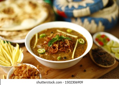 Chicken Haleem Nicely Garnished and Served with all its sides