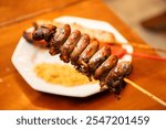 chicken heart skewer in close-up with blurred background in steakhouse