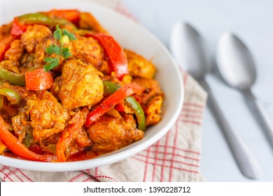 Chicken Jalfrezi Indian Curry With Bell Peppers / Capsicum And Tomatoes Served With Rice Close Up Selective Focus  Photo.
