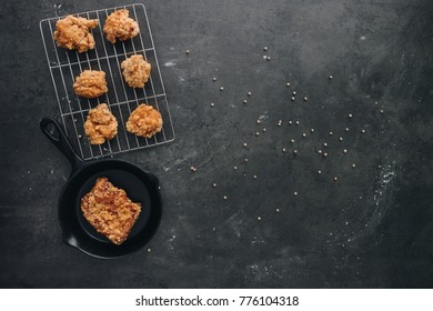 Chicken karaage japanese food in the tray on grey concrete background with herb and flour