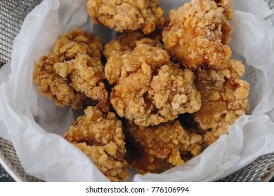 Chicken karaage japanese food in the tray on grey concrete background with herb and flour