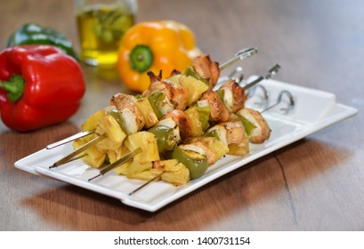 Chicken kebab with bell pepper on the white plate, close up.
