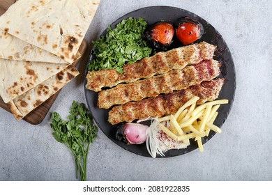 Chicken Kebab In Black Plate Tomato, Onion, French Fries And Bread Iraqi Food