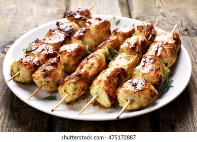 Chicken kebab on plate, close up view.