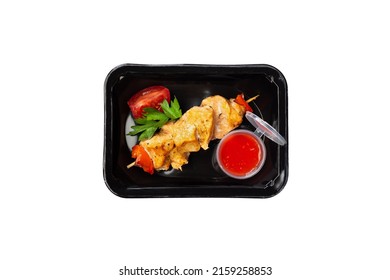 chicken kebab with tomato sauce in a plastic container