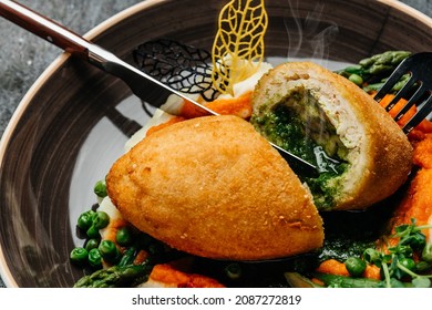 Chicken Kiev Cutlet with mashed potatoes and pumpkin decorated asparagus and peas. Restaurant menu, dieting, cookbook recipe. - Shutterstock ID 2087272819