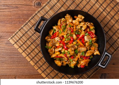 Chicken kung pao. Fried chicken pieces with peanuts and peppers. Top view. Flat lay. 