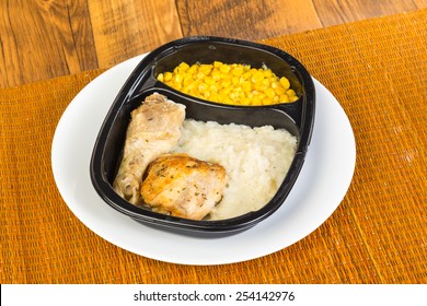 Chicken Leg And Thigh In Plastic Microwave Dish With Mashed Potatoes And Whole-grain Corn.  Typical Bland Appearance Of TV Dinner.