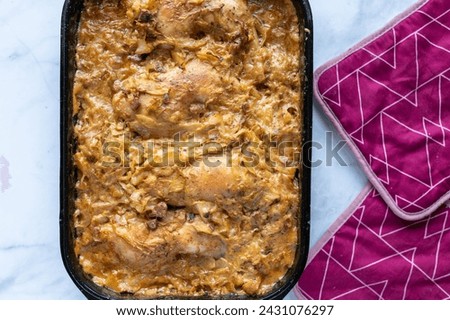 Chicken legs with delicious cabbage bacon sauce in a baking dish