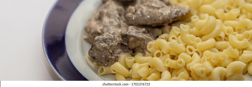 Chicken Liver Stewed In Sour Cream And A Side Dish Of Pasta In A Bowl On A White Background, Close-up. Healthy Food, Menu Concept Background