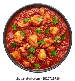 Chicken Madras Curry in black bowl isolated on white. Indian cuisine dish with with chicken meat and spicy masala gravy. Asian food and meal.