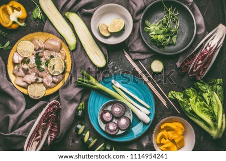 Similar – Image, Stock Photo Female hands making chicken skewers with vegetables for grilling