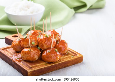 Chicken meatballs on skewers served with rice, easy appetizer