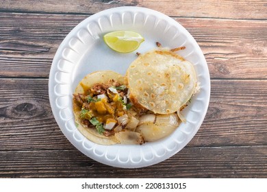 Chicken Mulita  Birria Taco On A White Plate With Grilled Onions And A Lime Wedge