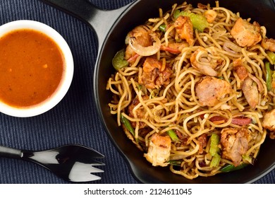 Chicken Noodles Served With Sauce On Blue Kitchen Cloth