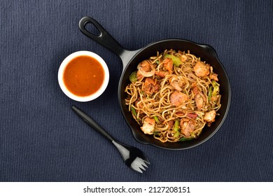 Chicken Noodles Served With Sauce On Blue Kitchen Cloth