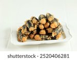 Chicken Nori Laver Roll Gimmari, Korean Snack Made from Minced Chicken with Seaweed Wrap on White Plate 