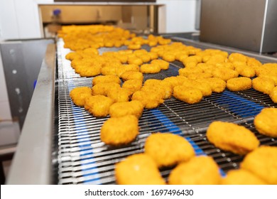 Chicken nuggets production line. Factory for the production of food from meat