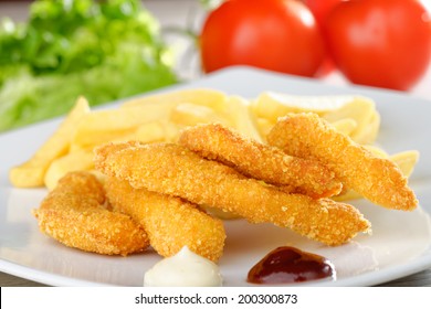 Chicken Nuggets/sticky Fingers And French Fries On A White Plate 