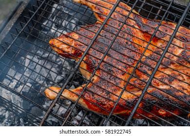 Chicken on the grill over coals in grid