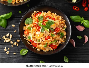 Chicken Pad Thai with eggs, bean sprouts, peanuts and spring onion - Shutterstock ID 2249635559