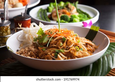 Chicken pad Thai with a variety of other fine Thai food dishes.  Shallow depth of field. - Shutterstock ID 191769974
