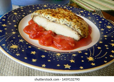 
		Chicken Parm And Marinara Sauce On A White Plate With A Border Of Blue Stars			