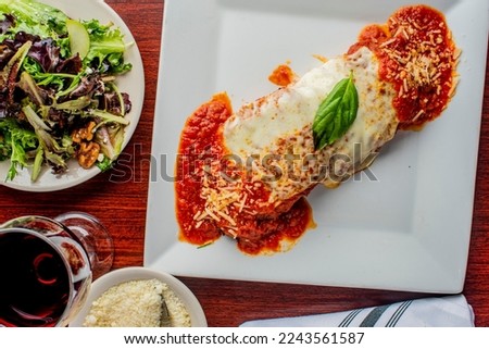 Chicken parmesan or parmigiana. Traditional Italian comfort dish. Chicken breast in breadcrumbs fried with marinara sauce, melted mozzarella, parmigiana and provolone cheeses and Italian parsley. 