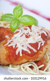 Chicken Parmigiana On A White Plate With Spaghetti