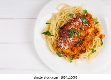 Chicken Parmigiana On A White Plate With Spaghetti. View From Above