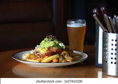 Chicken Parmigiana Pub Lunch On A Table With A Glass Of Cold Beer And Seating In Background. The Meal Is Mexican Chicken Parmigiana With Chips And Coleslaw. Chicken Parma Or Parmi.