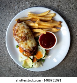 Chicken Parmigiana Served With Chips And Veggies