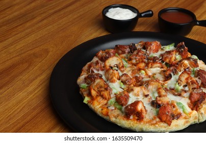 Chicken Pizza Or Chicken Pan Pizza Served In Black Dish On Wooden Background. Selective Focus