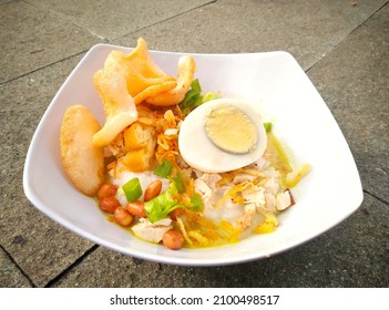 Chicken Porridge With Slice Of Boiled Egg, Nut, Leek, Shrimp Crackers, Fried Onion And Cakwe