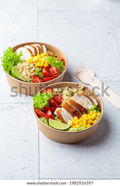Chicken and quinoa salad with corn and tomatoes\
in a craft eco bowl. Zero waste, to go food, recycling packaging,\
eco friendly concept.