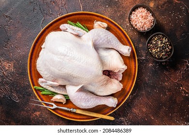 Chicken, Raw Poultry In A Rustic Plate With Rosemary. Dark Background. Top View