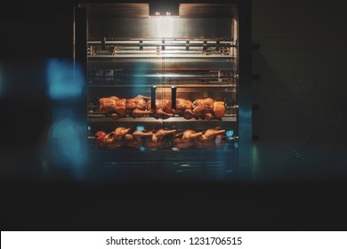Chicken roasting in commercial rotisserie oven - Shutterstock ID 1231706515