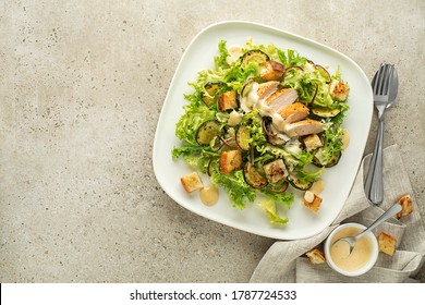 Chicken Salad. Chicken Caesar Salad. Caesar Salad with grilled chicken and croutons. Grilled chicken breast and fresh green salad close up