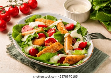 Chicken Salad with crispy breaded chicken breast and fresh vegetables, roman lettuce,  tomato with home mayonnaise dressing. 