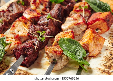 Chicken, Salmon and Meat Shish Kebabs on Parchment with Sauces