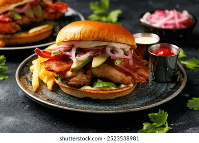 Chicken sandwich, burger with bacon, pickled onion, avocado, mayonnaise and french fries - Powered by Shutterstock