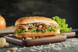 Chicken Sandwich With Mushrooms And Mozzarella Cheese And Lettuce On Cutting Bored  