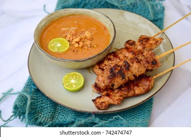 Chicken Satay or Sate Ayam - Indonesian food. Skewered and grilled meat, served with a peanut sauce. 