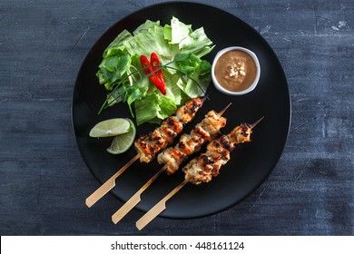 Chicken Satay Or Sate Ayam - Malaysian Famous Food. Satay, Modern Indonesian And Malay Spelling Of Sate, Is A Dish Of Seasoned, Skewered And Grilled Meat, Served With A Peanut Sauce. Top View