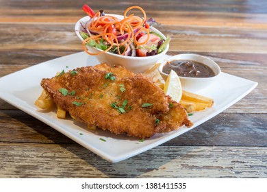 
Chicken Schnitzel  With Chips Gravy And Salad