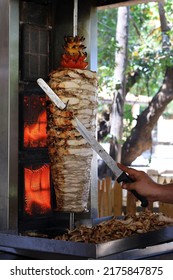 A Chicken Shawarma Skewer Roasting On A Rotating Pole.