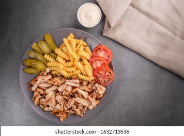 Chicken Shawerma meal, served with fries, pickles, tomatoes and tahini sauce