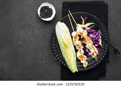 Chicken Skewers With Coleslaw On A Dark Background. Top View